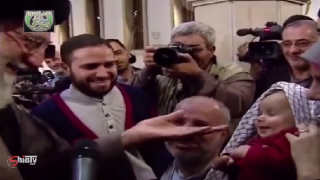 Clip - Imam Khamenei presented his Basiji Romaal to a Revolutionary Baby